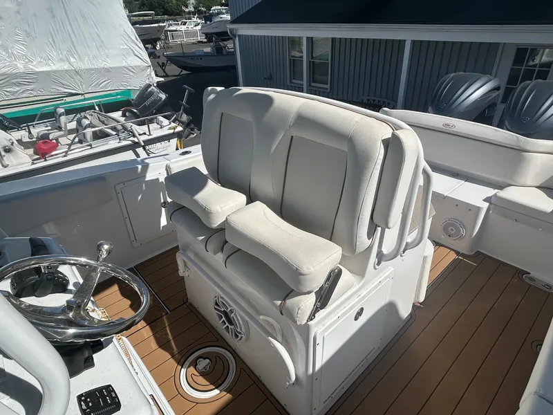 Slide: The Image of 2022 Sea Hunt Ultra 275 SE boat interior with helm seat and steering wheel. - 13