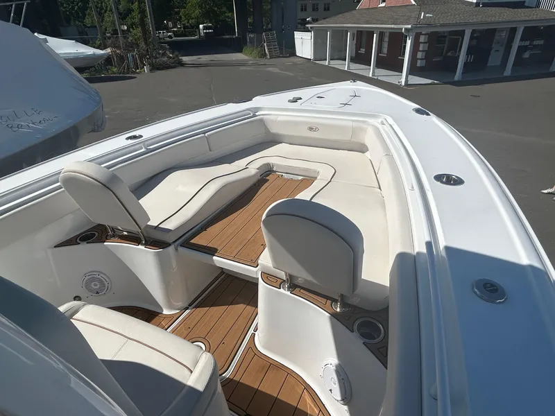 Slide: The Image of 2022 Sea Hunt Ultra 275 SE boat with spacious seating and teak flooring. - 14