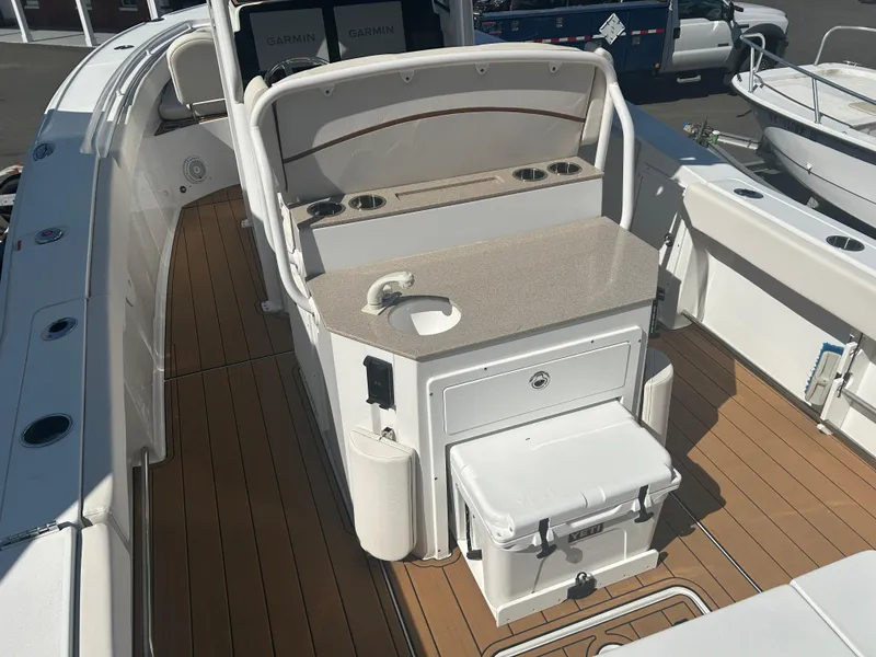Slide: The Image of 2022 Sea Hunt Ultra 275 SE boat interior with seating and storage features. - 16