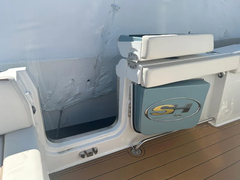 Slide: The Image of 2022 Sea Hunt Ultra 275 SE boat interior with seating and storage compartment. - 17
