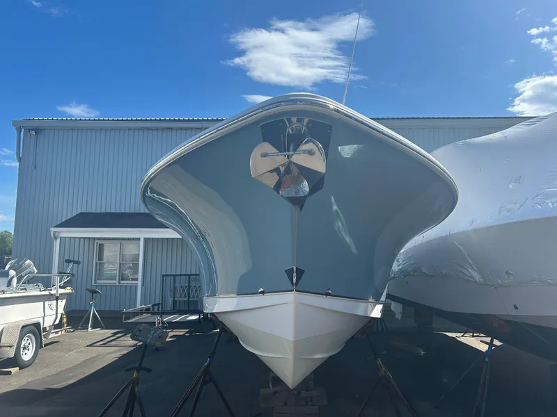 Slide: The Image of 2022 Sea Hunt Ultra 275 SE boat in storage, front view under clear blue sky. - 3