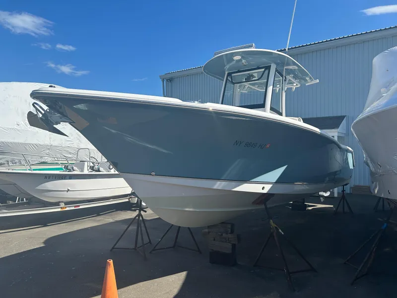 Slide: The Image of 2022 Sea Hunt Ultra 275 SE boat on display outdoors. - 5