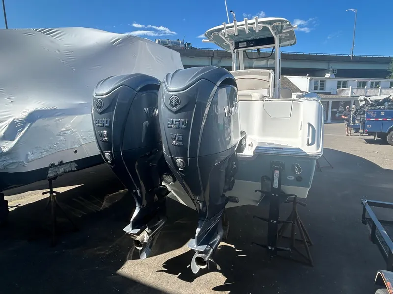 Slide: The Image of 2022 Sea Hunt Ultra 275 SE boat with dual Yamaha 250 engines in a marina setting. - 7