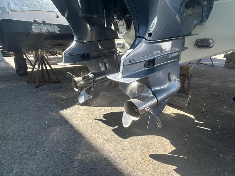 Slide: The Image of Twin outboard motors on a 2022 Sea Hunt Ultra 275 SE boat, parked on a trailer. - 9