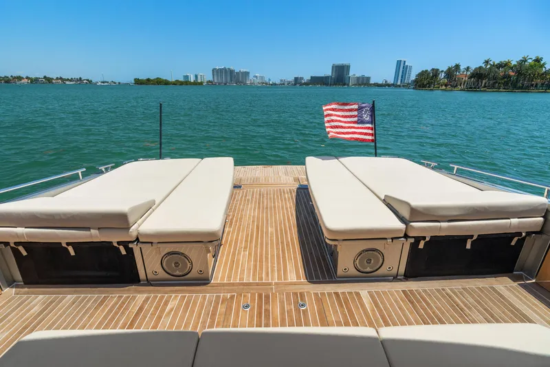 Slide: The Image of Luxurious 2019 CNM Continental 54T yacht deck with sun loungers and American flag, ocean view. - 12
