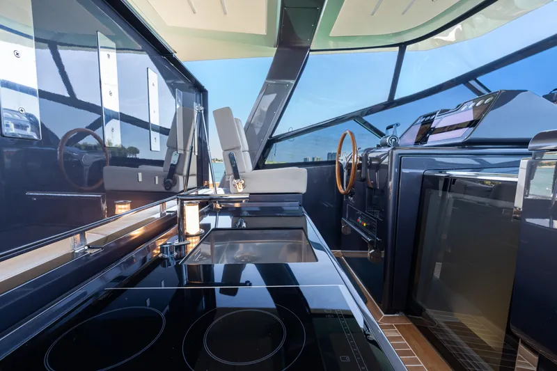 Slide: The Image of Luxurious interior of 2019 CNM Continental 54T yacht with modern kitchen and steering area. - 16