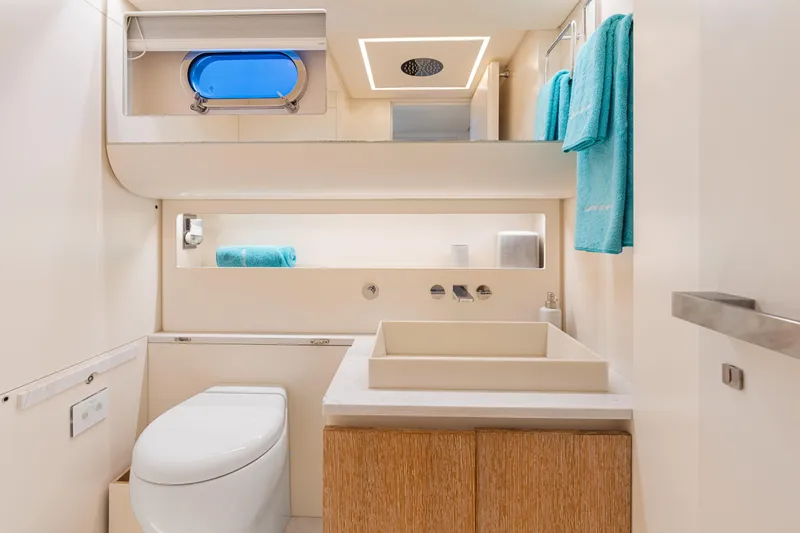 Slide: The Image of Luxurious yacht bathroom with modern fixtures, blue towels, and sleek design on CNM Continental 54T. - 24