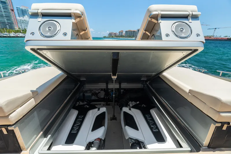Slide: The Image of 2019 CNM Continental 54T yacht engine compartment with dual MAN engines, open hatch, ocean backdrop. - 25