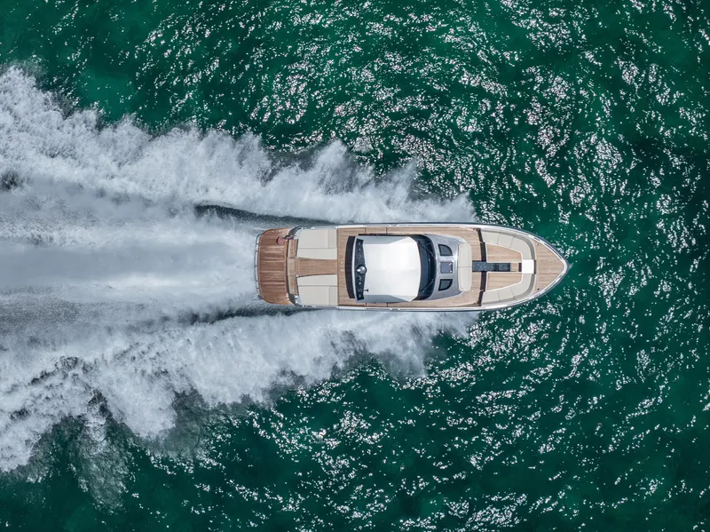 Slide: The Image of Aerial view of 2019 CNM Continental 54T yacht speeding on turquoise water. - 3