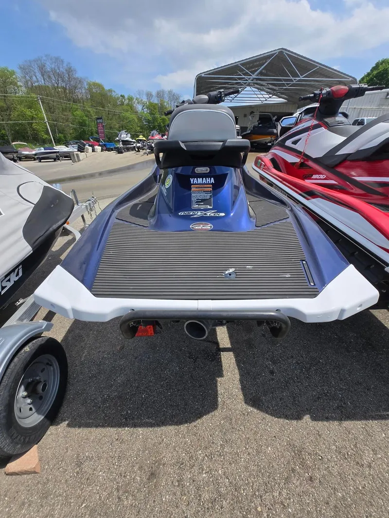 Slide: The Image of 2018 Yamaha VX110 jet ski, blue and white, parked outdoors on a sunny day. - 3