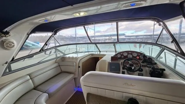 Slide: The Image of 2005 Rinker Fiesta Vee 342 boat interior with steering console and seating area. - 12