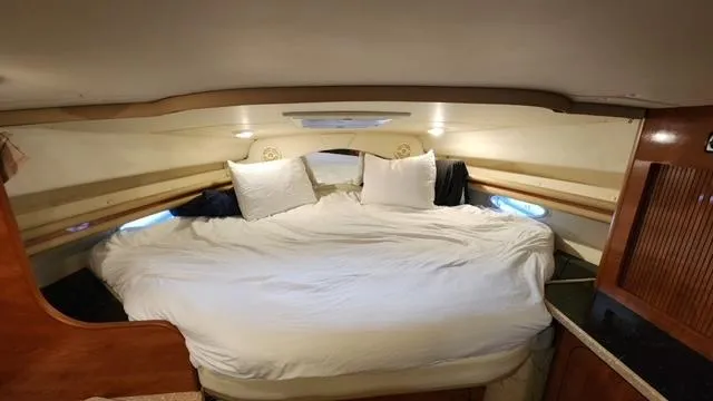 Slide: The Image of Interior cabin of 2005 Rinker Fiesta Vee 342 with cozy bed and pillows. - 18