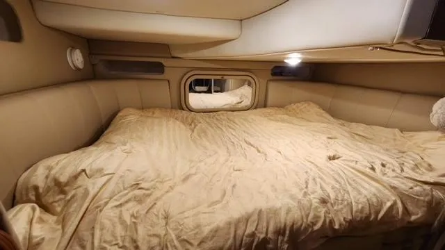 Slide: The Image of 2005 Rinker Fiesta Vee 342 cabin with a cozy bed and ambient lighting. - 25