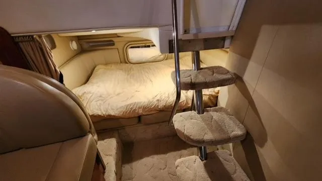 Slide: The Image of 2005 Rinker Fiesta Vee 342 cabin interior with cozy bed and carpeted stairs. - 27