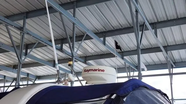 Slide: The Image of 2005 Rinker Fiesta Vee 342 with Raymarine radar under metal roof. - 3