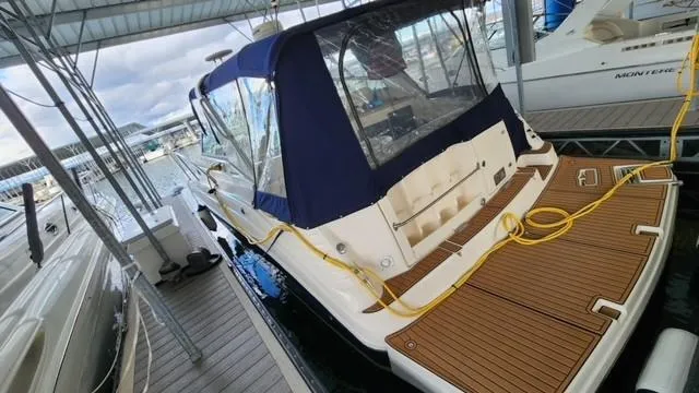 Slide: The Image of 2005 Rinker Fiesta Vee 342 docked under a covered marina. - 4