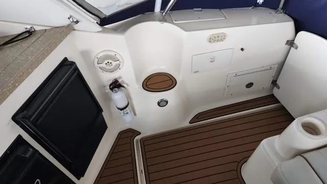 Slide: The Image of 2005 Rinker Fiesta Vee 342 boat interior with wood flooring and storage compartments. - 7