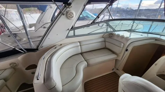 Slide: The Image of 2005 Rinker Fiesta Vee 342 boat interior with beige seating and wood flooring. - 8