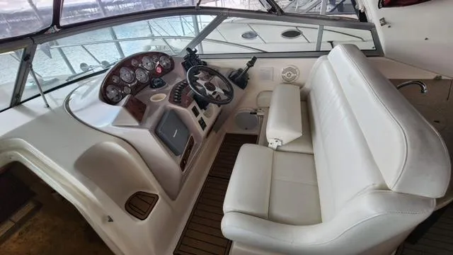 Slide: The Image of 2005 Rinker Fiesta Vee 342 helm with white seating and control panel. - 9