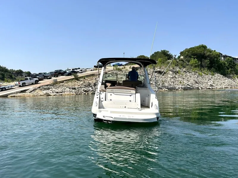 Slide: The Image of Sea Ray 280 Sundancer 2017 boat on water near rocky shoreline. - 12