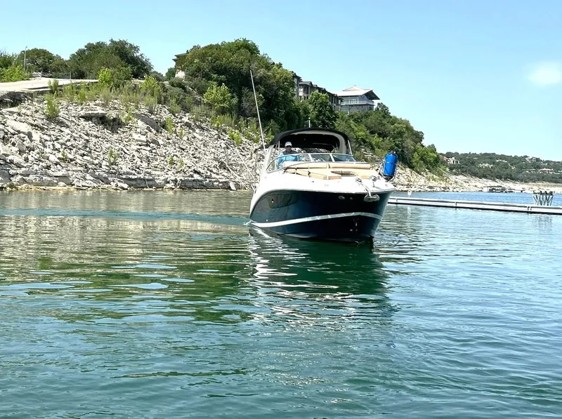 Slide: The Image of 2017 Sea Ray 280 Sundancer on calm water near rocky shoreline. - 18
