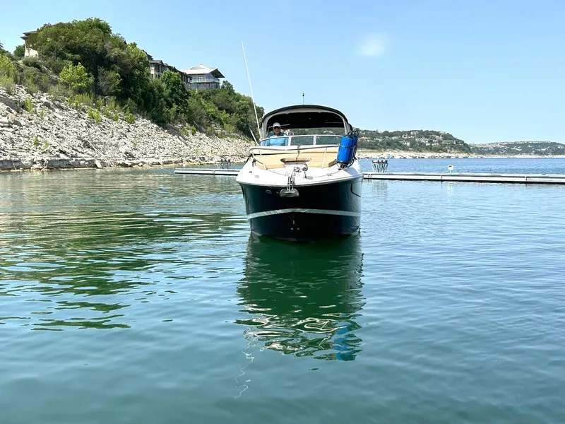 Slide: The Image of 2017 Sea Ray 280 Sundancer boat on calm lake with scenic shoreline. - 19