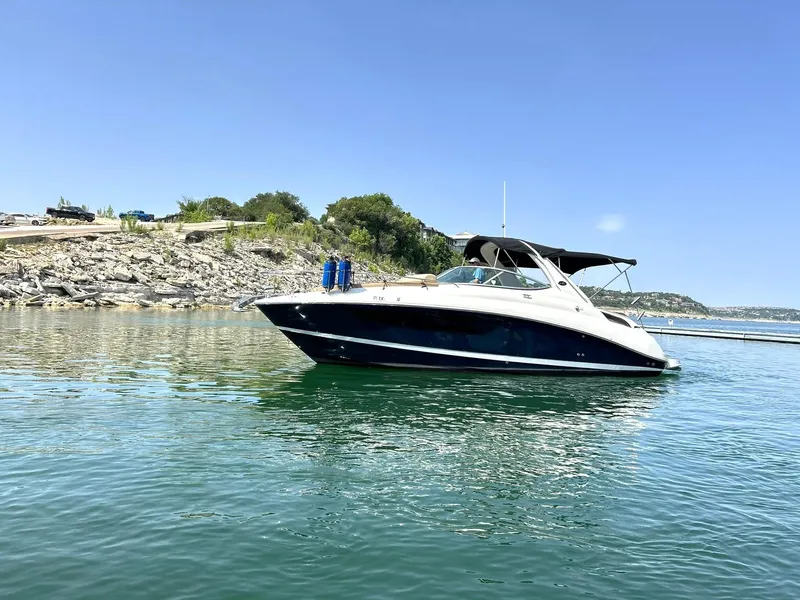 Slide: The Image of 2017 Sea Ray 280 Sundancer boat on calm water under clear blue sky. - 21