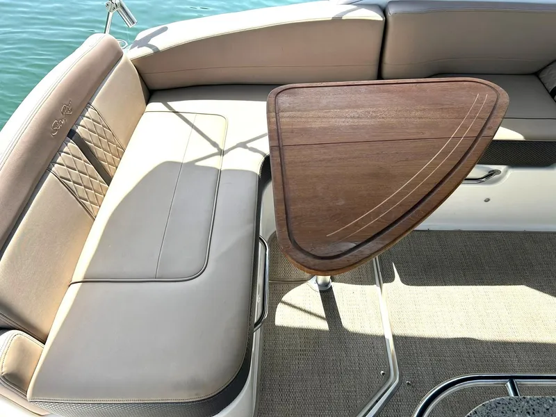 Slide: The Image of 2017 Sea Ray 280 Sundancer interior with elegant seating and wooden table. - 24