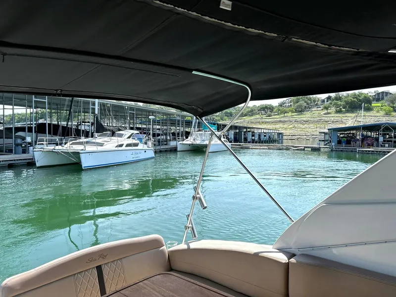 Slide: The Image of 2017 Sea Ray 280 Sundancer docked in a marina with calm waters and surrounding boats. - 31