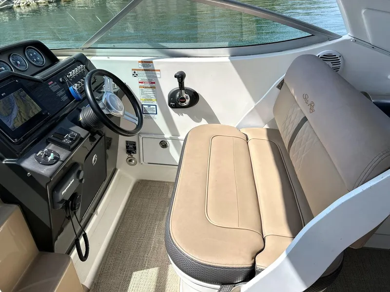 Slide: The Image of Cockpit of 2017 Sea Ray 280 Sundancer with steering wheel and beige seating. - 32