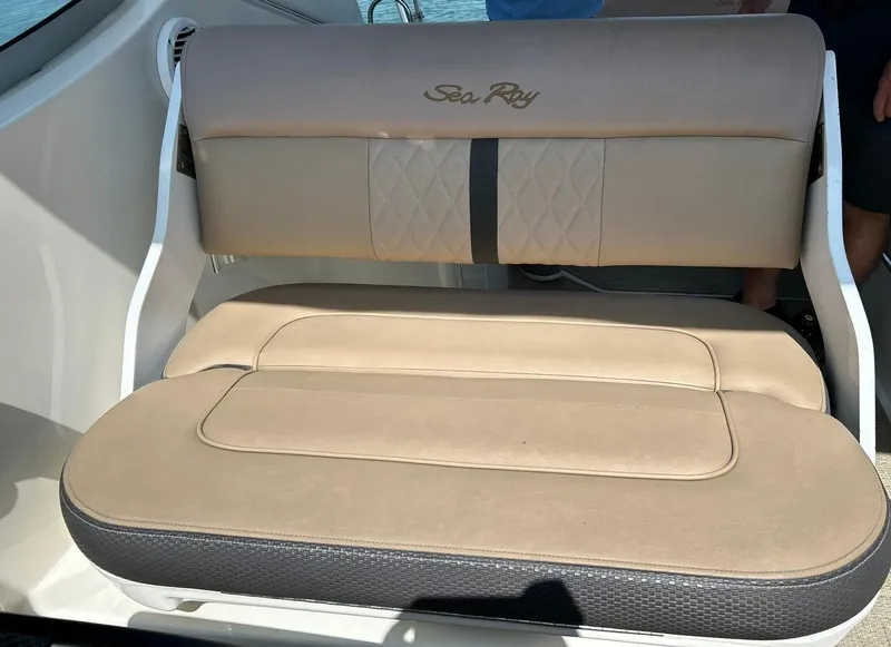 Slide: The Image of 2017 Sea Ray 280 Sundancer boat seat with beige upholstery and logo. - 33