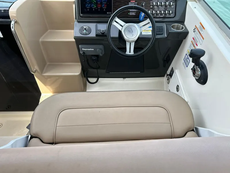 Slide: The Image of 2017 Sea Ray 280 Sundancer helm with steering wheel and control panel. - 34