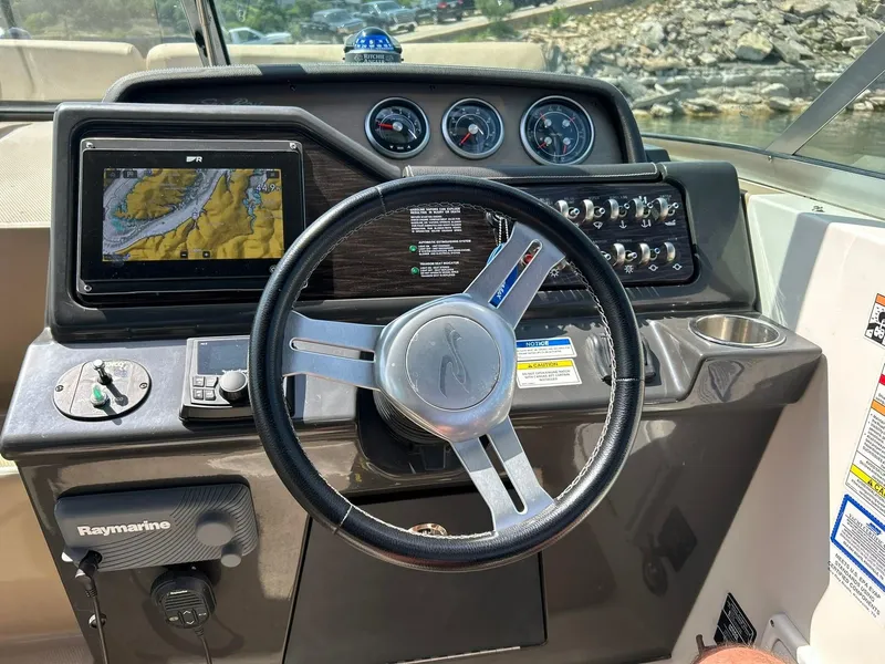Slide: The Image of 2017 Sea Ray 280 Sundancer dashboard with steering wheel, GPS, and control panel. - 36