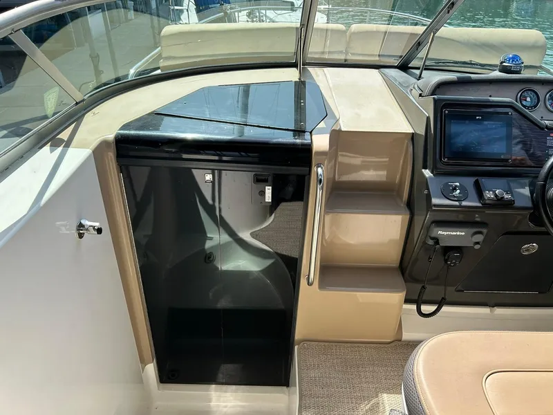 Slide: The Image of 2017 Sea Ray 280 Sundancer cockpit with helm, steps, and cabin entry. - 48