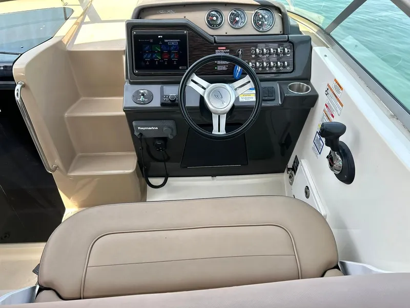 Slide: The Image of 2017 Sea Ray 280 Sundancer helm with steering wheel, gauges, and navigation system. - 5