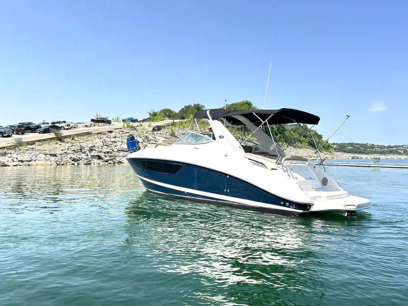 Slide: The Image of 2017 Sea Ray 280 Sundancer boat on calm water under clear blue sky. - 9