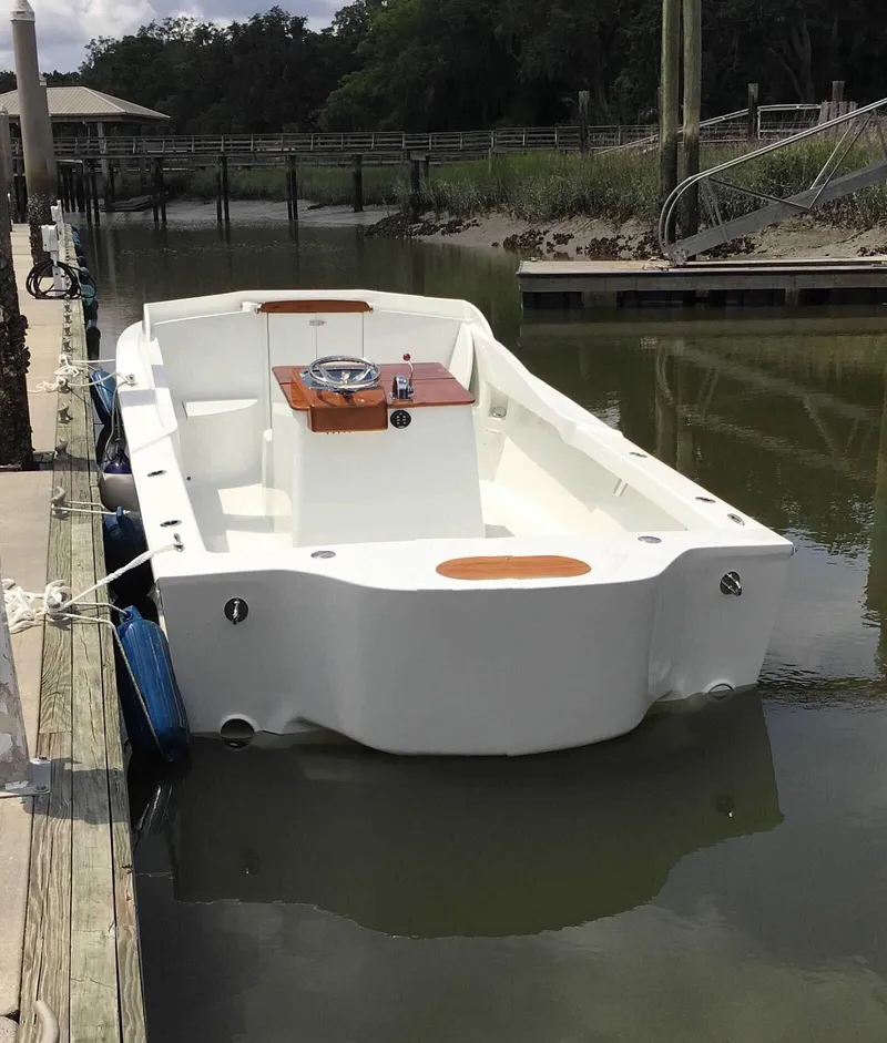 Slide: The Image of 2018 Blackfin Custom 25 boat docked in a calm marina setting. - 11
