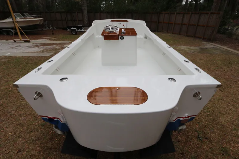 Slide: The Image of 2018 Blackfin Custom 25 boat with sleek white design and wooden accents. - 3