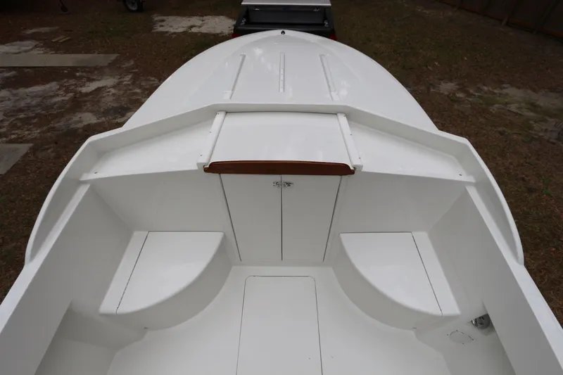 Slide: The Image of 2018 Blackfin Custom 25 boat interior, featuring white seating and storage compartments. - 4