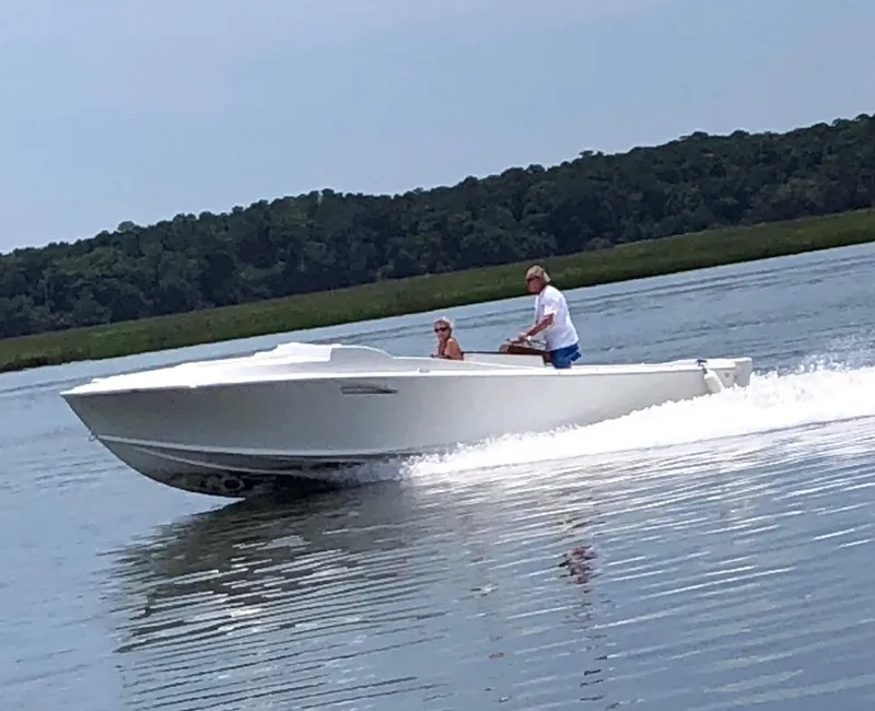 Slide: The Image of 2018 Blackfin Custom 25 boat cruising on a calm lake with two passengers. - 9