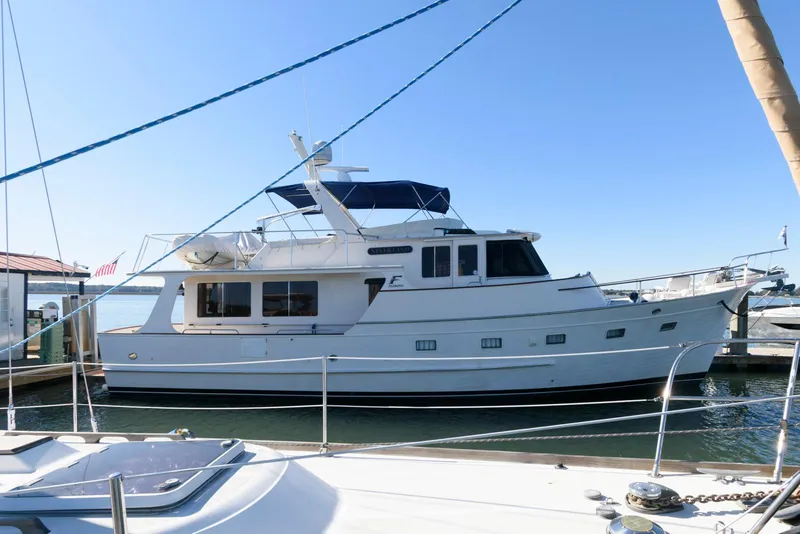 Slide: The Image of 1990 Fleming 50 yacht docked in marina under clear blue sky. - 1