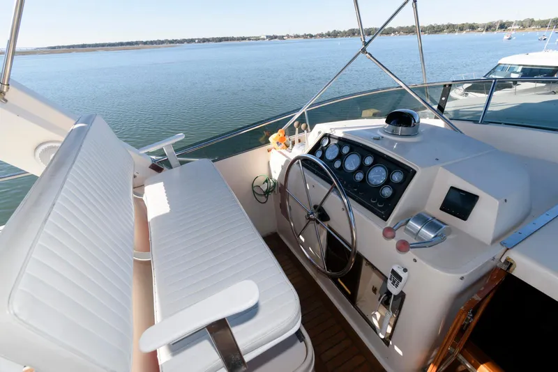 Slide: The Image of Helm of 1990 Fleming 50 yacht with white seating and control panel. - 10