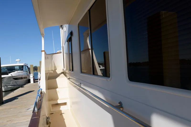 Slide: The Image of Side view of a 1990 Fleming 50 yacht docked at a marina. - 14