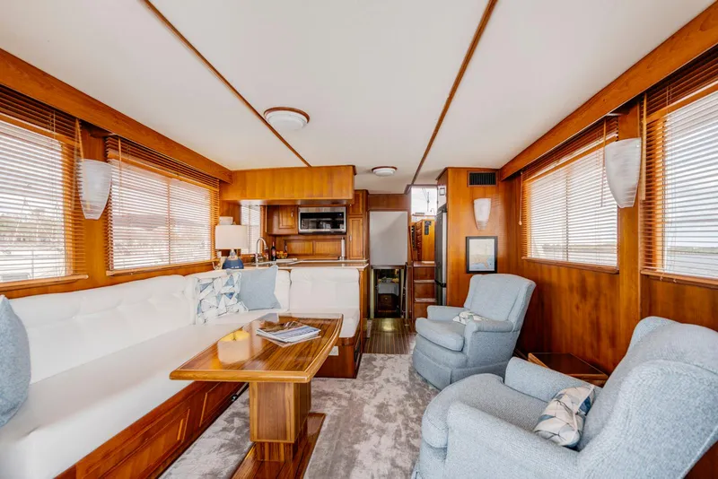 Slide: The Image of Luxurious interior of a 1990 Fleming 50 yacht with wooden accents and comfortable seating. - 15