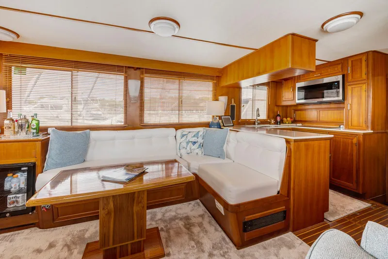 Slide: The Image of Luxurious interior of a 1990 Fleming 50 yacht with wood finishes and cozy seating. - 16