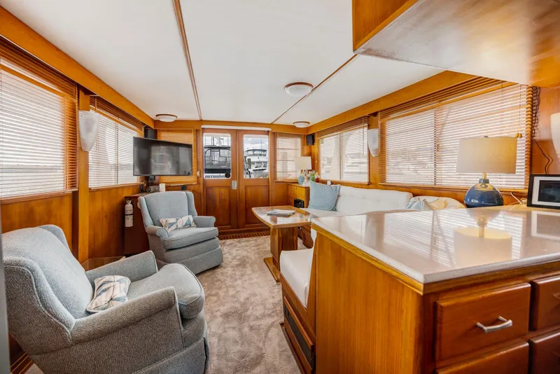 Slide: The Image of Luxurious 1990 Fleming 50 yacht interior with cozy seating and elegant wood finishes. - 19