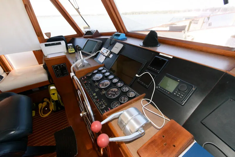 Slide: The Image of Helm of 1990 Fleming 50 yacht with navigation instruments and controls. - 23