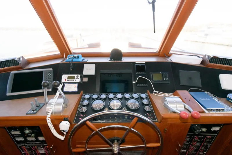 Slide: The Image of Cockpit of a 1990 Fleming 50 yacht with navigation instruments and steering wheel. - 24