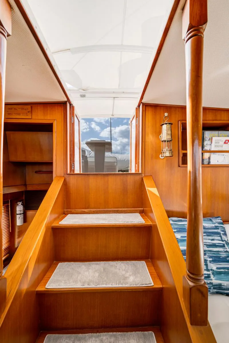 Slide: The Image of Interior of 1990 Fleming 50 yacht with wooden stairs and nautical decor. - 26