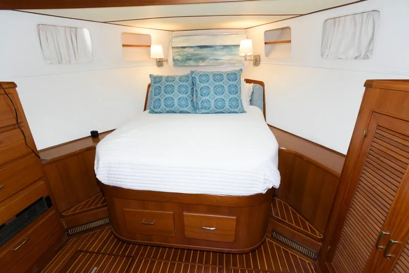 Slide: The Image of Cozy bedroom in 1990 Fleming 50 yacht with wood accents and nautical decor. - 27